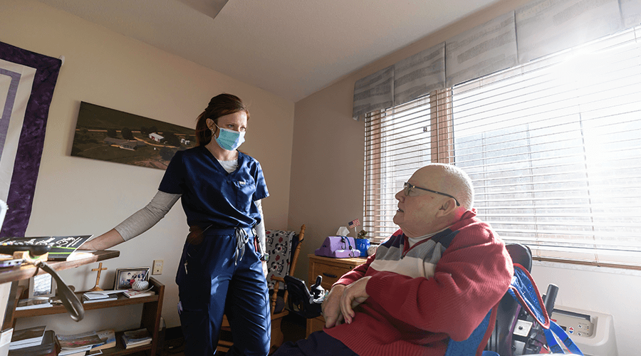 Good Samaritan Society LPN, Kayla Finzen talking with long-term care resident.